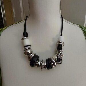 Black, White, Silver Metal Necklace on leather roping.